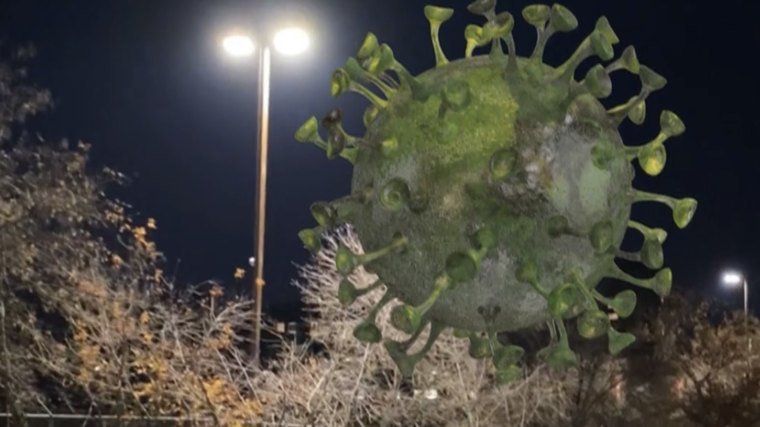 Augmented reality motion tracking of a virus floating in a parking lot at night