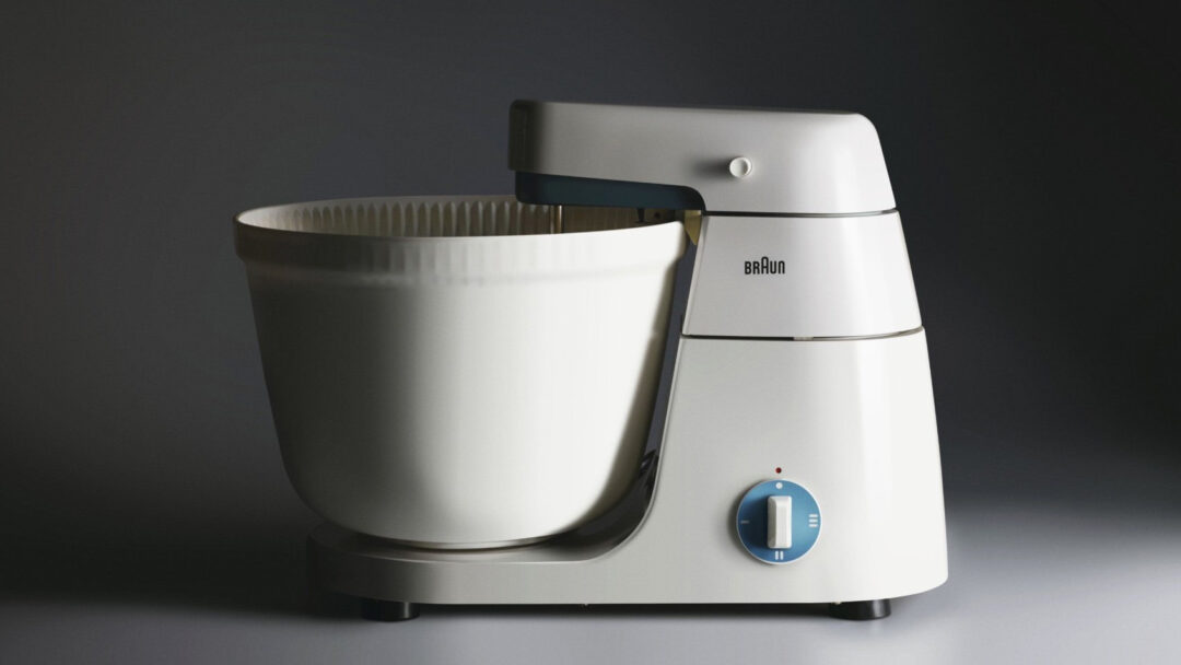Braun KM3 kitchen machine with a white body, mixing bowl and blue control dial.